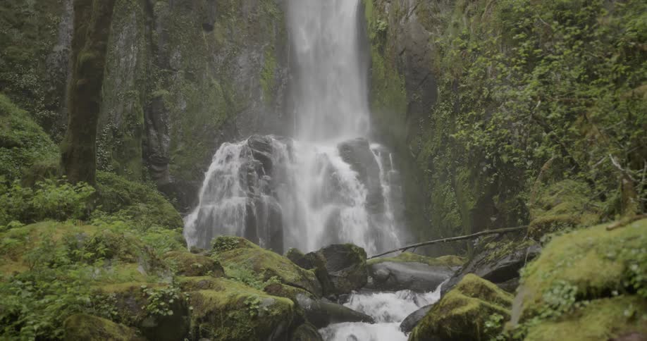 Water cascades down the side of a hill to the creek below
