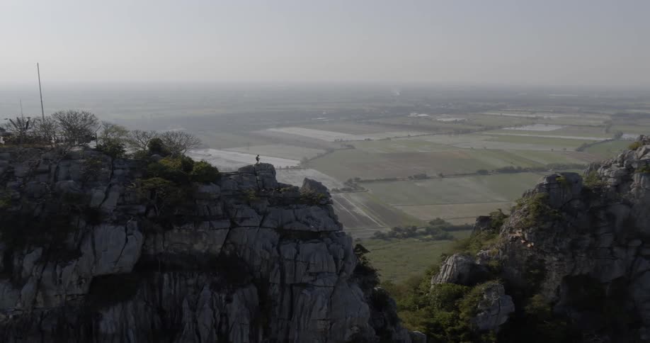 The tall mountains are near the farm land below