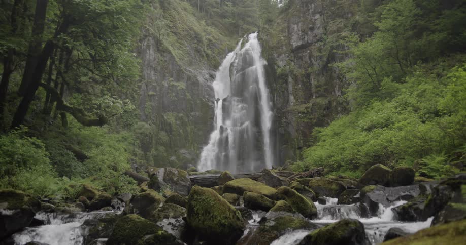 Waterfall splashes down into a rocky creek below