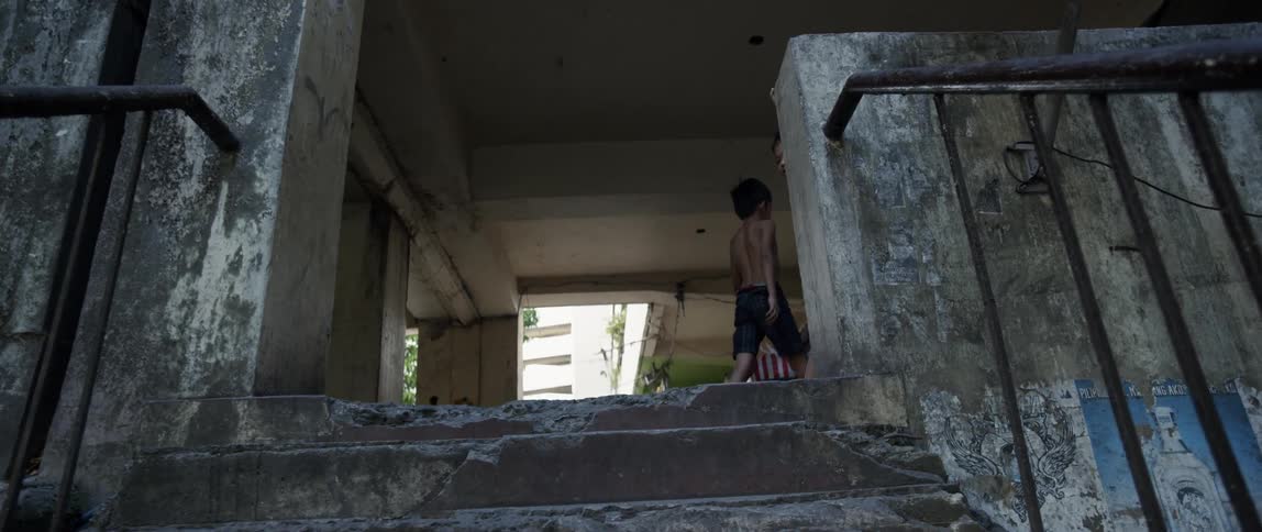 Children stand on top of a staircase outside