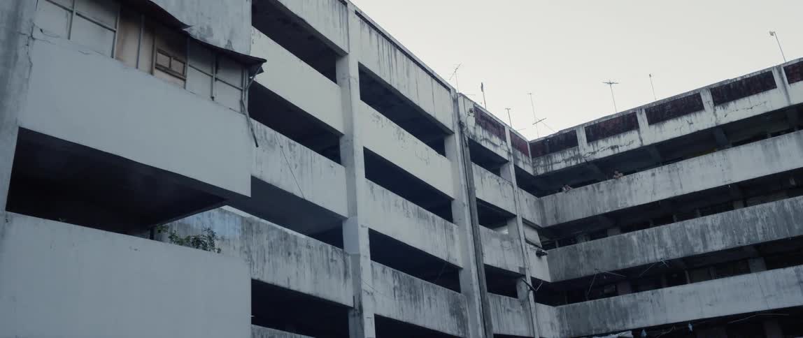 Antennas stand on top of a large parking garage