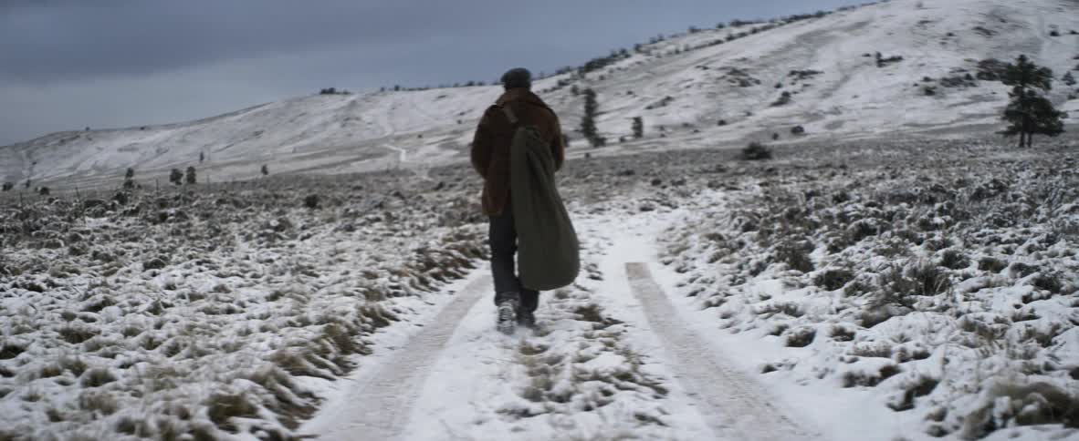 A person walking on a snow covered trail
