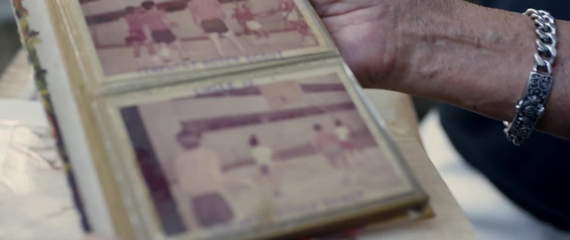 Elderly woman looking through photographs outside
