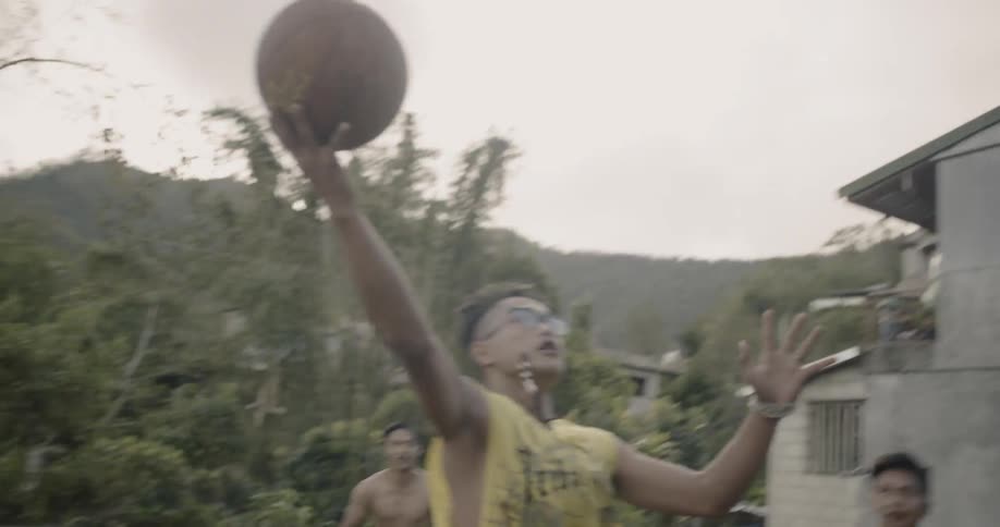 Children play basketball in a yard