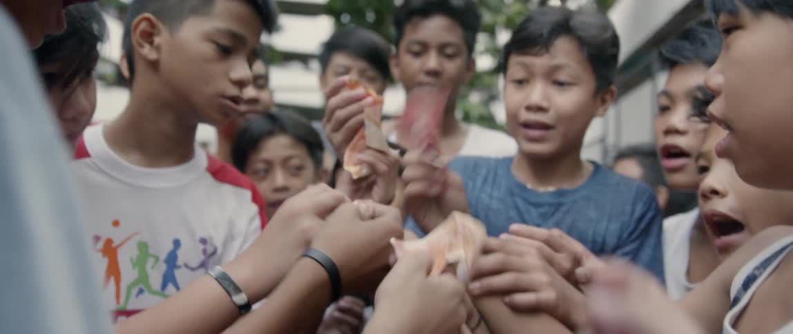 Group of boys hand one boy money