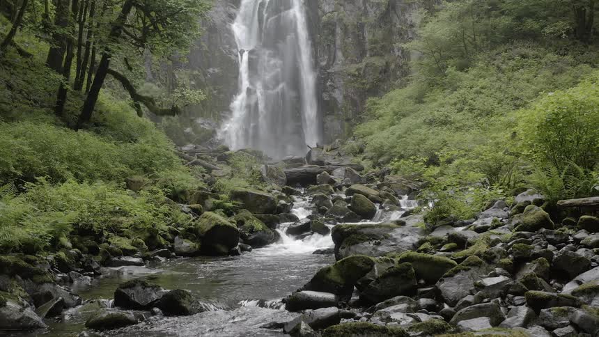 The small stream is running from the waterfall