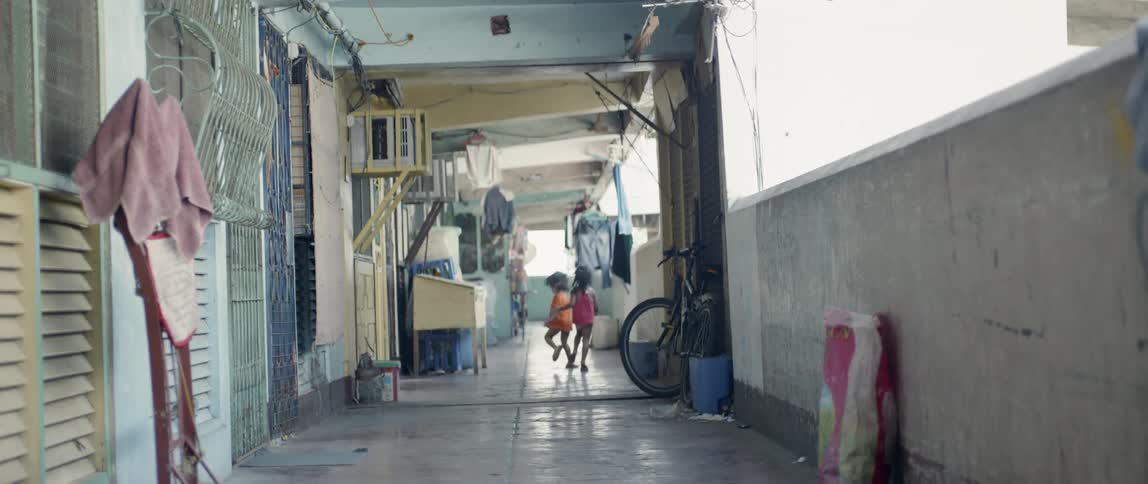 Two children run down the hall