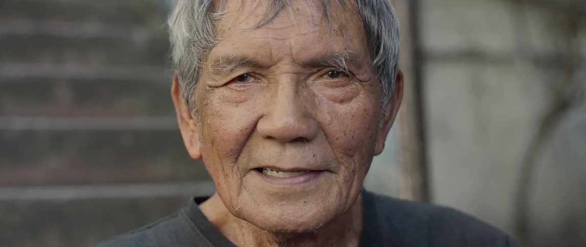 A man smiles by the steps