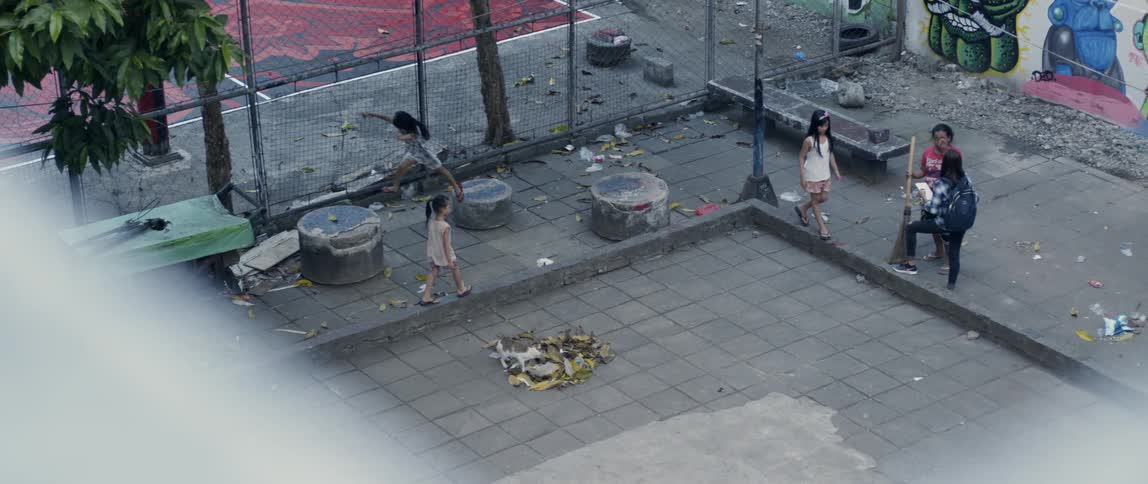 People walk around the square by the building