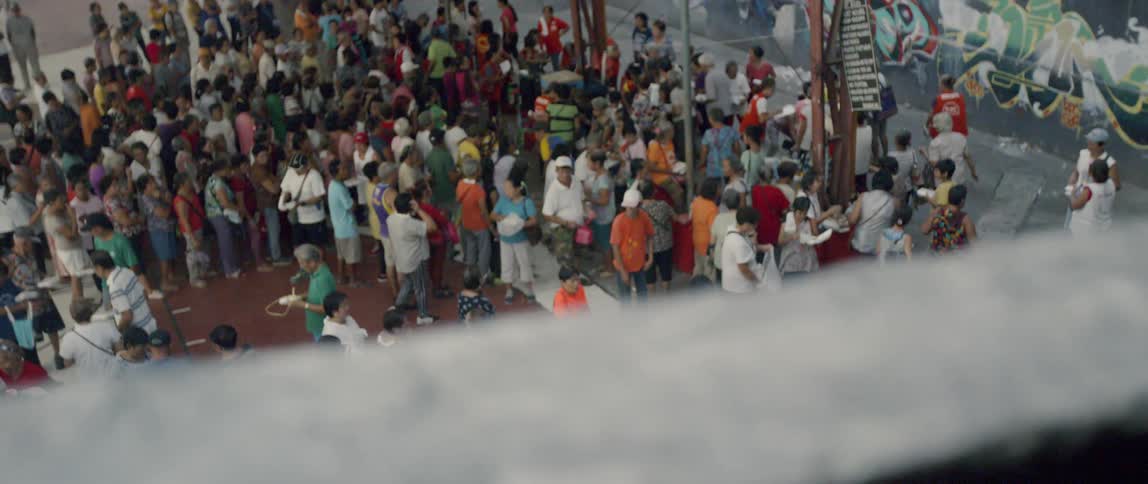 A crowd of people is gathered outside