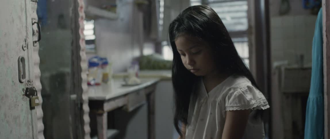 A young girl looks sad in a bathroom