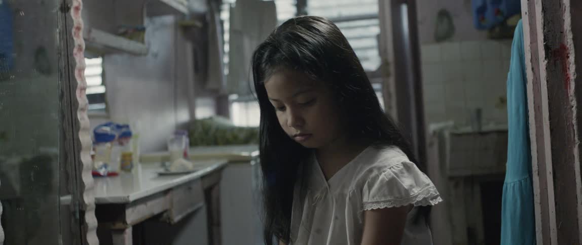 The girl looks up in the kitchen