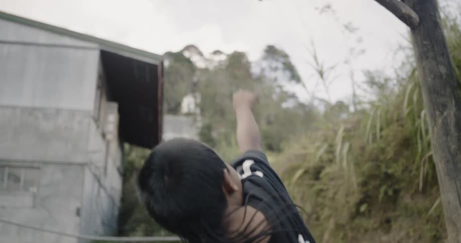 A teenager tosses a ball to a boy who then dribbles to the basket and scores