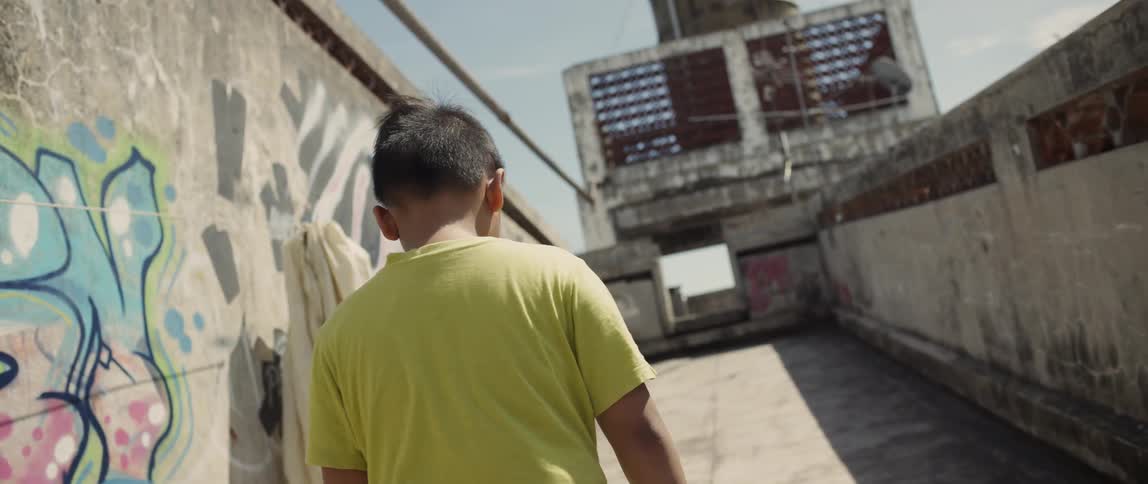 A child walks up the concrete walkway