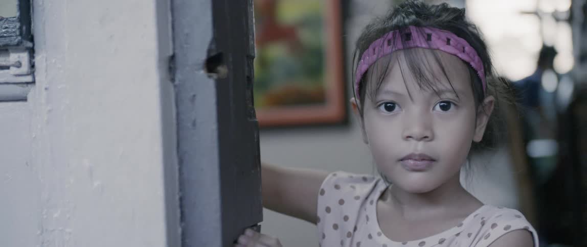 A young girl stands in the doorway