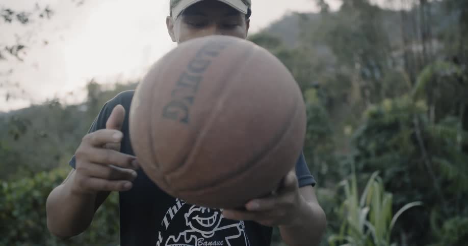 Man spins a basketball around in his hands
