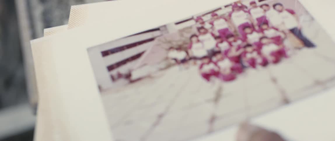 Hands hold an old photograph