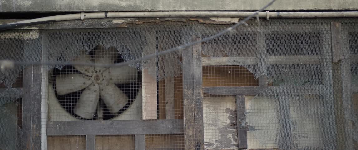 Fan on a dilapidated building rotates around