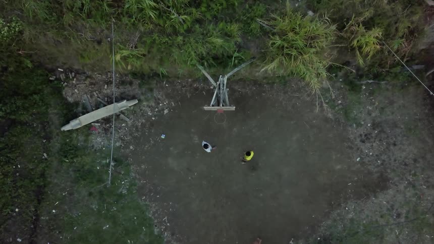 People play a game of basketball in the yard