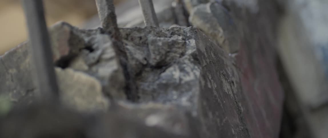 Metal bars are encased in broken concrete