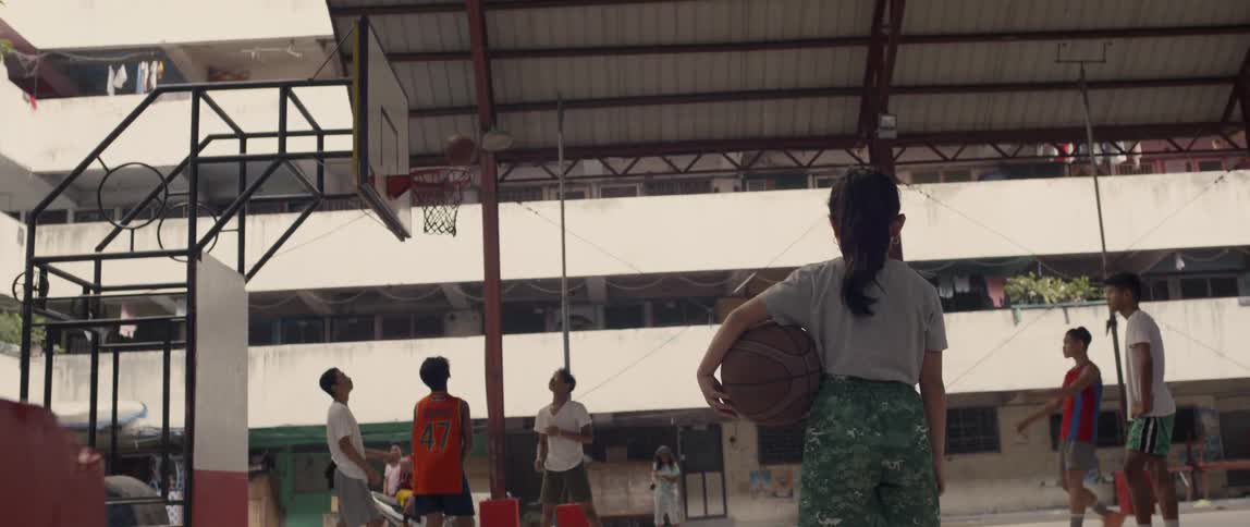 Kids play basketball on a basketball court