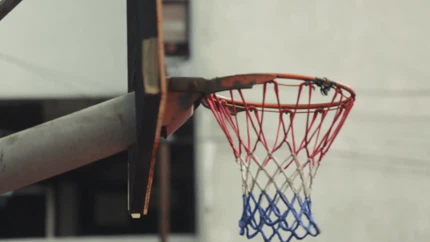 A basketball bounces off the rim of a hoop