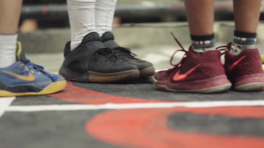 Kids kick their shoes on the black top
