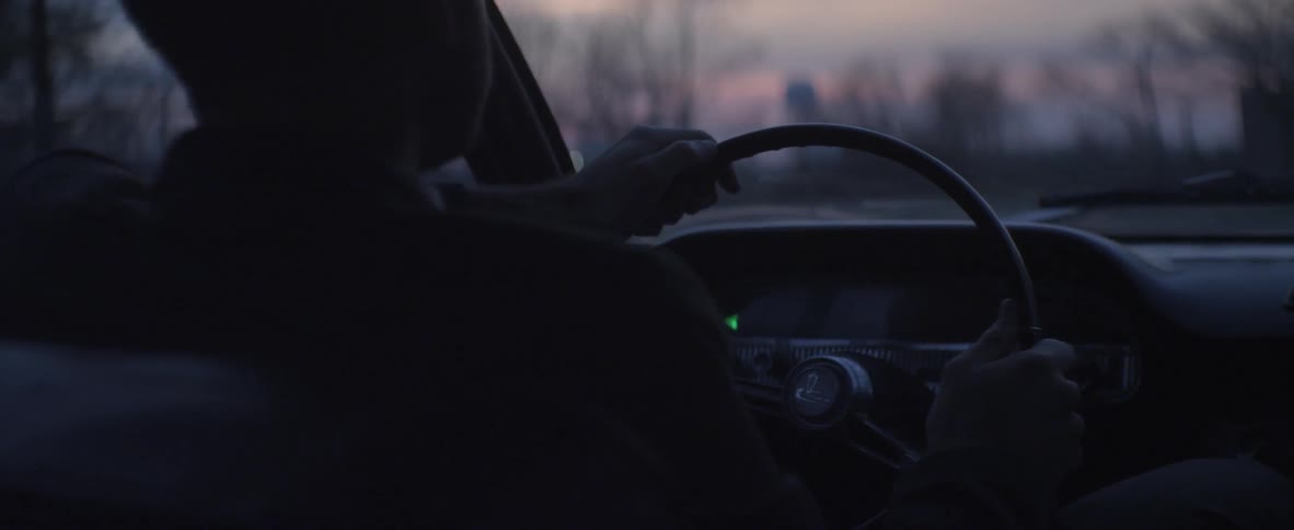 A guy is driving his car in the night time
