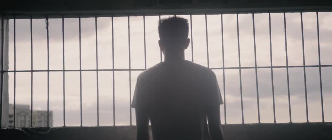 The man is watching from the balcony