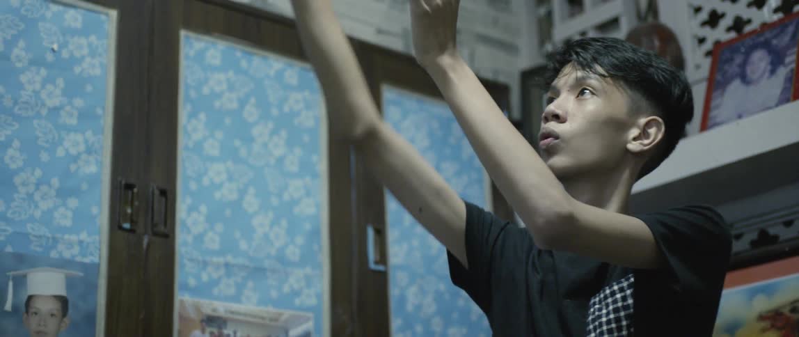 Young man tosses a basketball then catches it