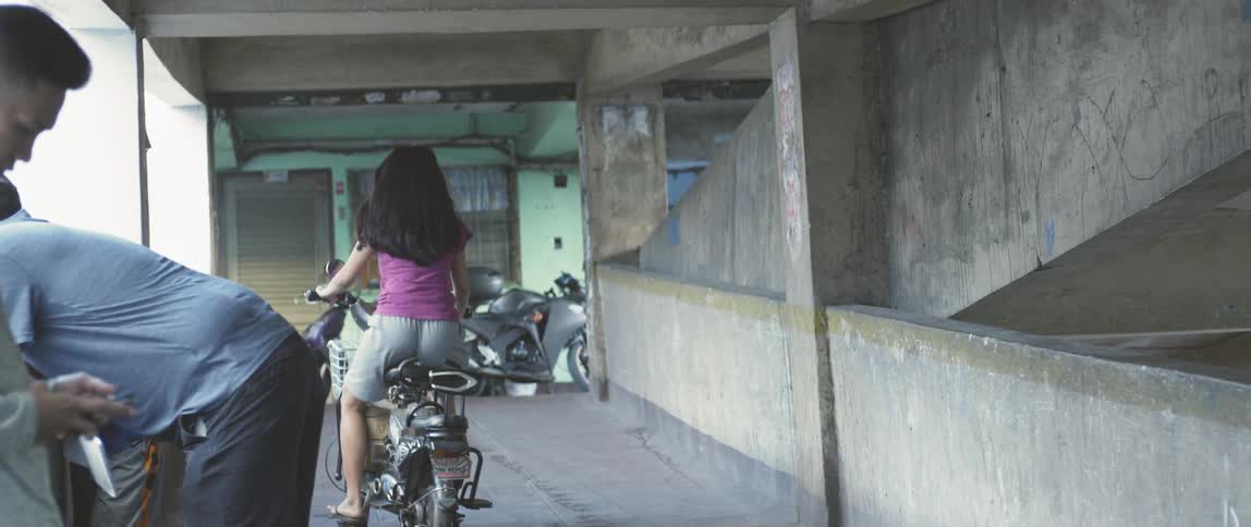 Girl rides on a small motorbike