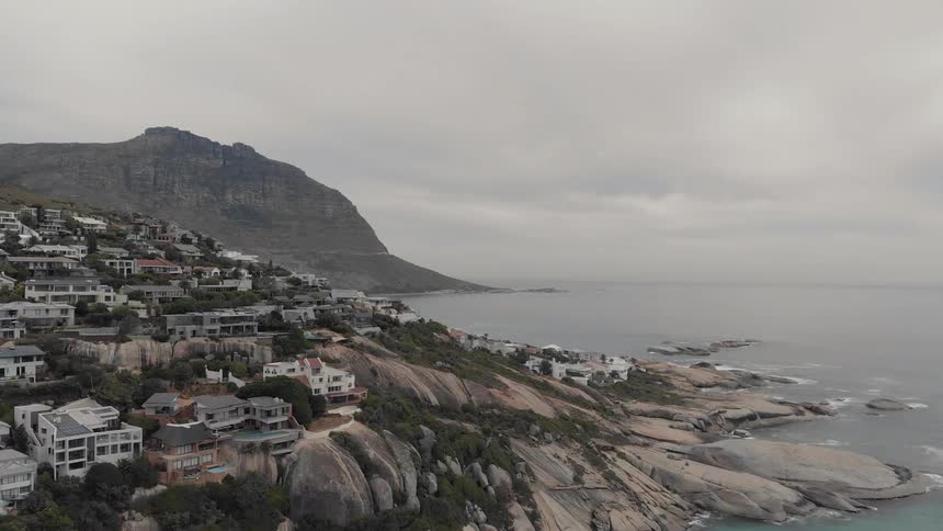 Buildings sit near the water under a cloudy sky