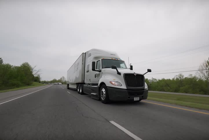 A big rig truck is driven down the highway road