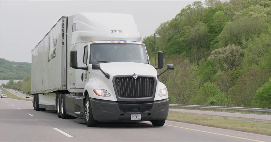 A big rig truck rides on the highway road