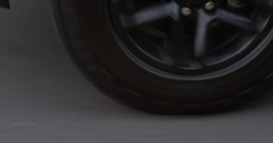 A big rig truck tire travels on the road