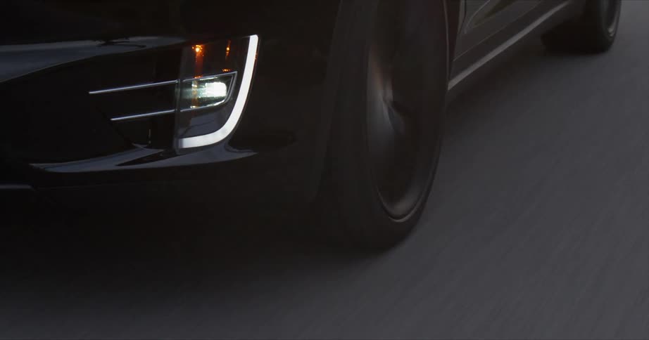 A car is traveling down the road