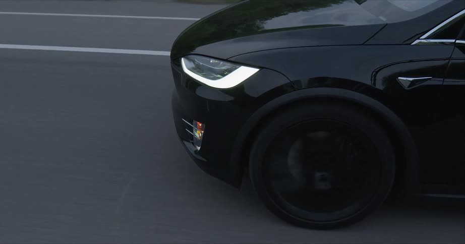 The black car has tinted windows on the road