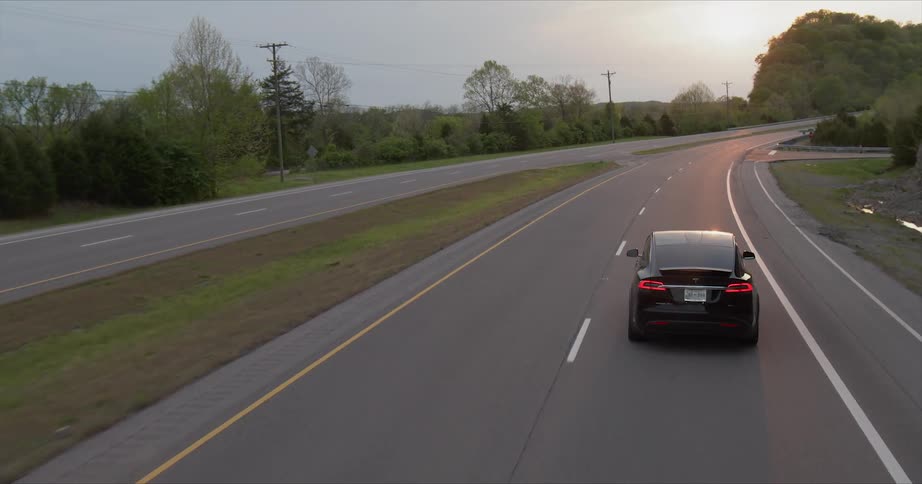 The car breaks briefly as it travels on the road