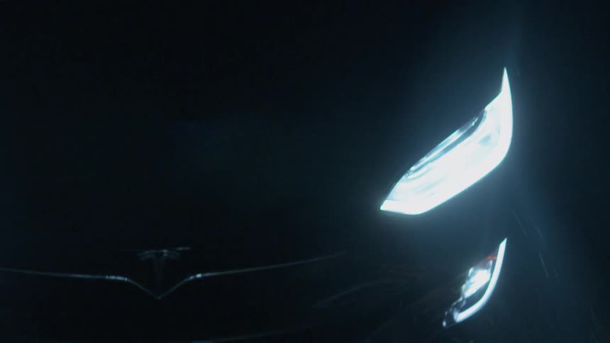 The headlights of a car traveling at night