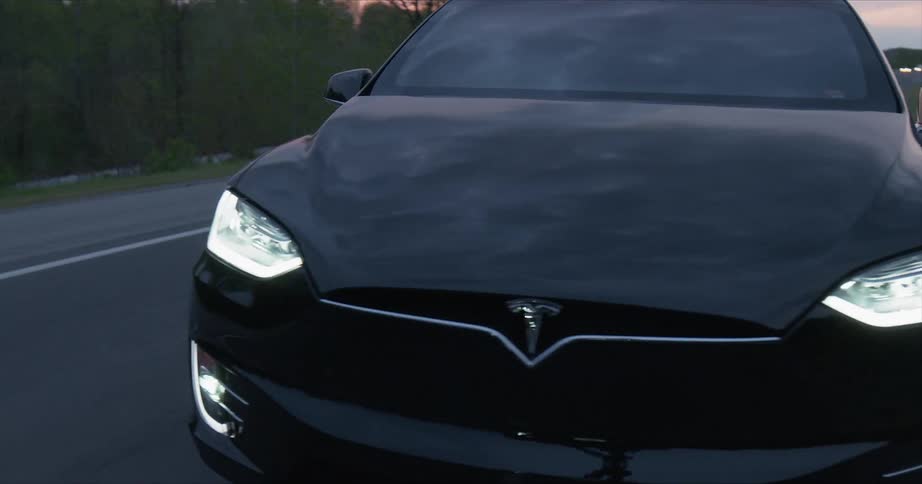 A tesla car switches lanes on the road