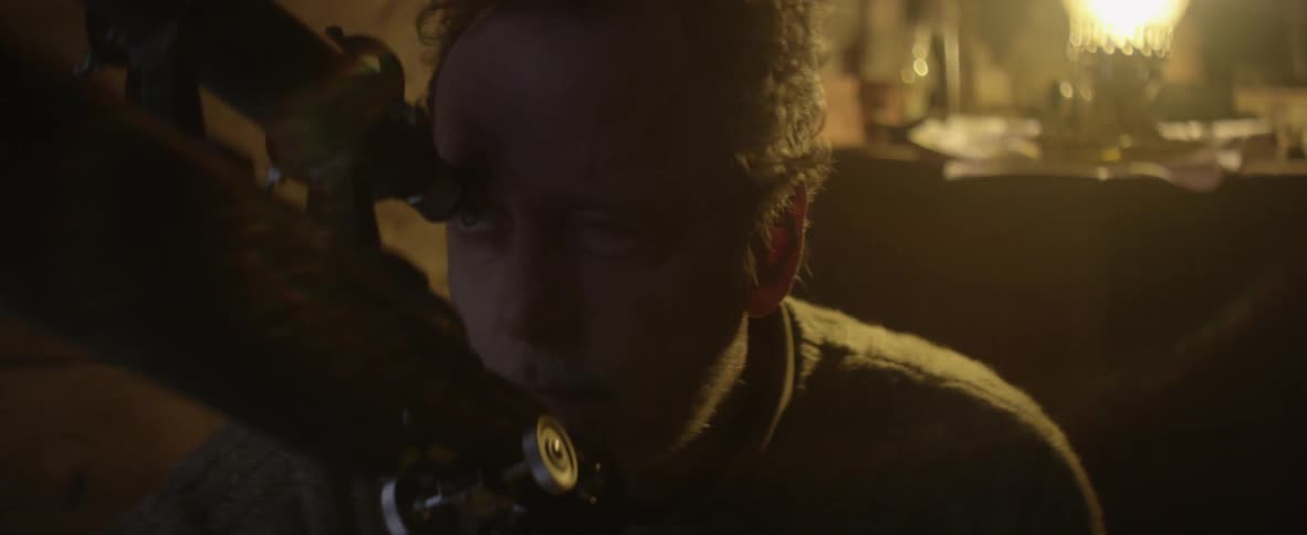 Man walks over to look through a telescope