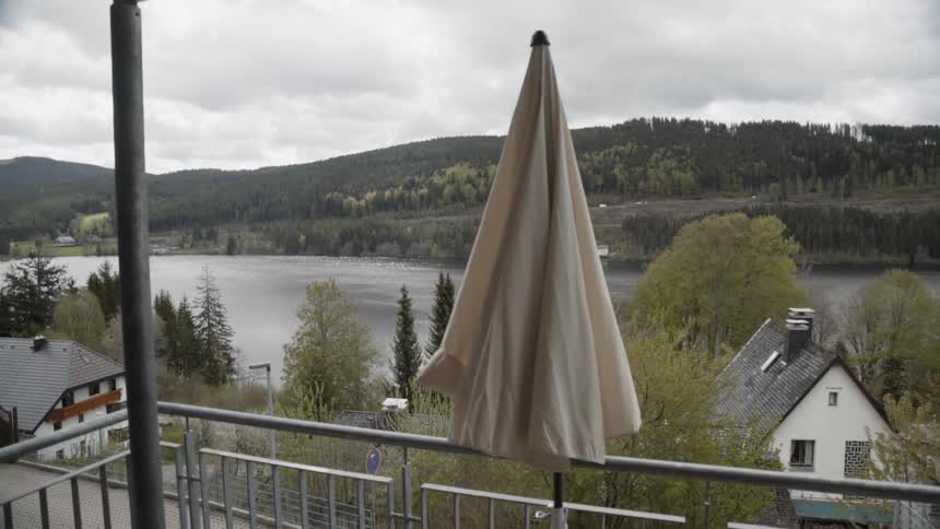 An umbrella sits on a patio