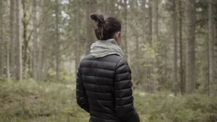 Woman stands in a forest