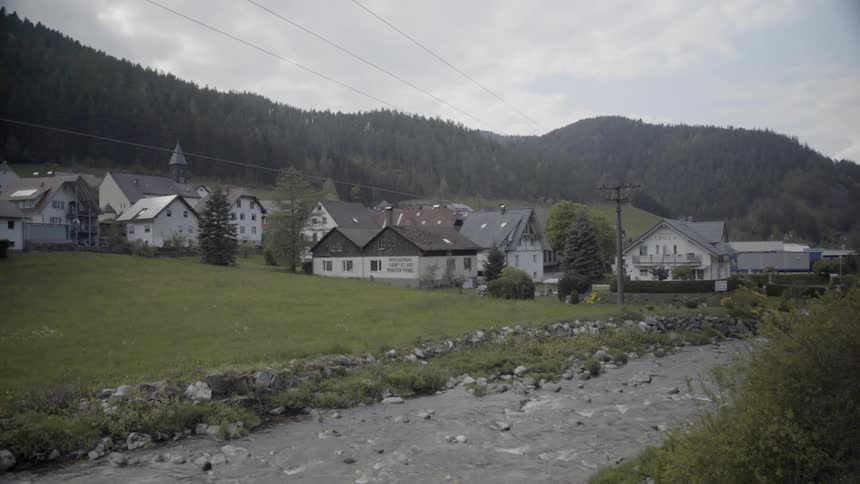 The stream leads to a town by the mountains