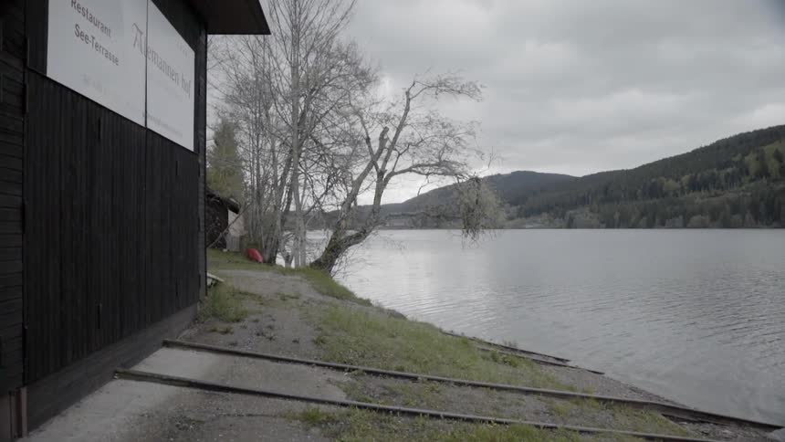 Lake waters flow under overcast skies