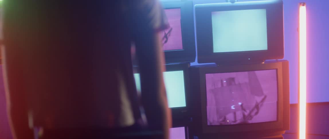 A woman stands in a room with strobing lights