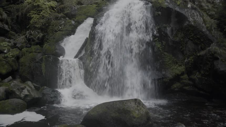 Water falls down stream off of the cliff
