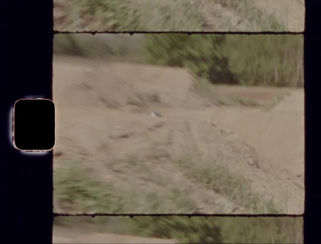 Man goes over jumps on a dirt bike