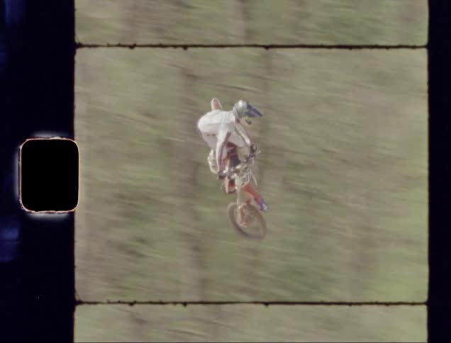 Man rides a bike over a ramp and flies through the air