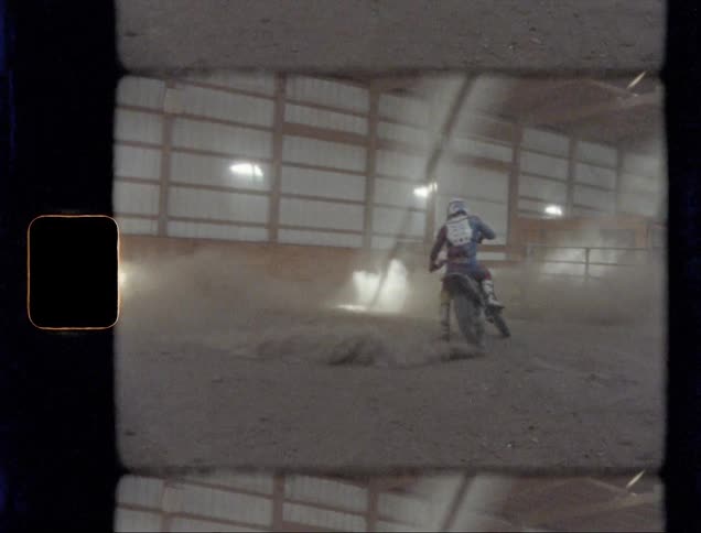 A person is spinning his dirt bike in a circle